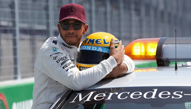 Hamilton abbraccia il casco regalato dalla famiglia Senna. 